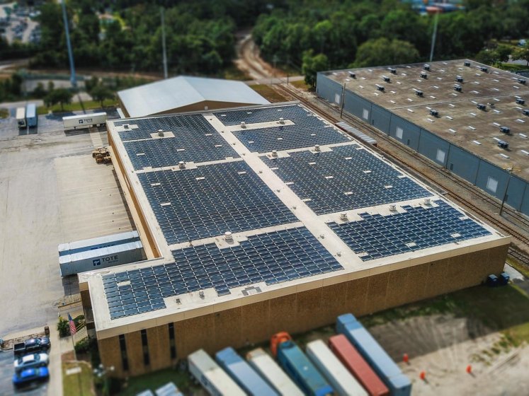 Solar panel installation on a warehouse, rooftop view