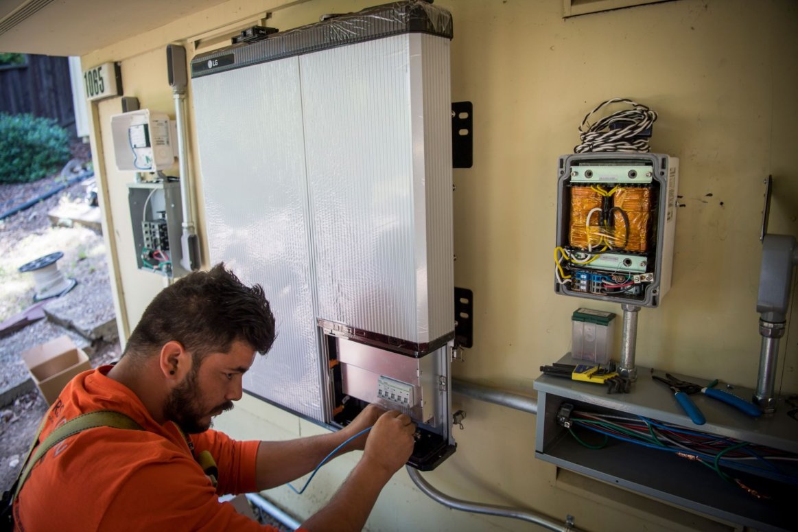 Contractor installing a solar battery