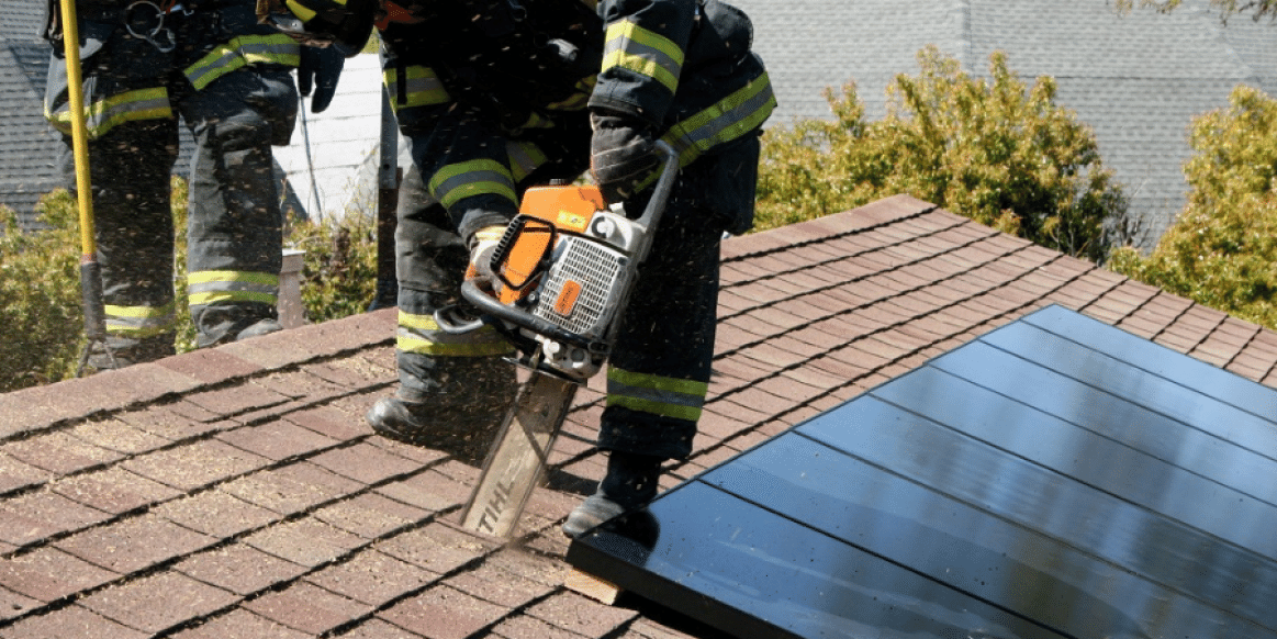 Firefighter entering a house with solar panels in an emergency situation
