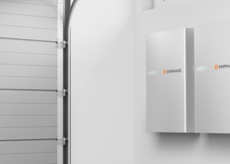 Enphase products displayed on the wall of a garage.