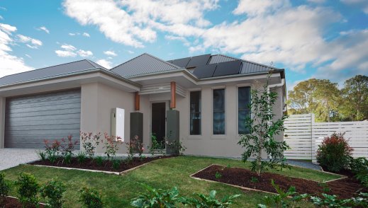 Tesla Powerwall 3 displayed on the side of a house powered by solar.
