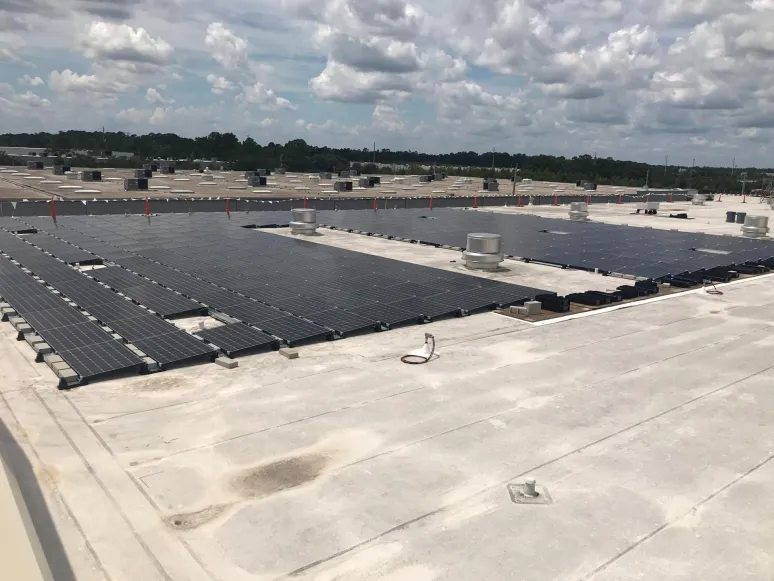 Solar panel installation on a warehouse, rooftop view