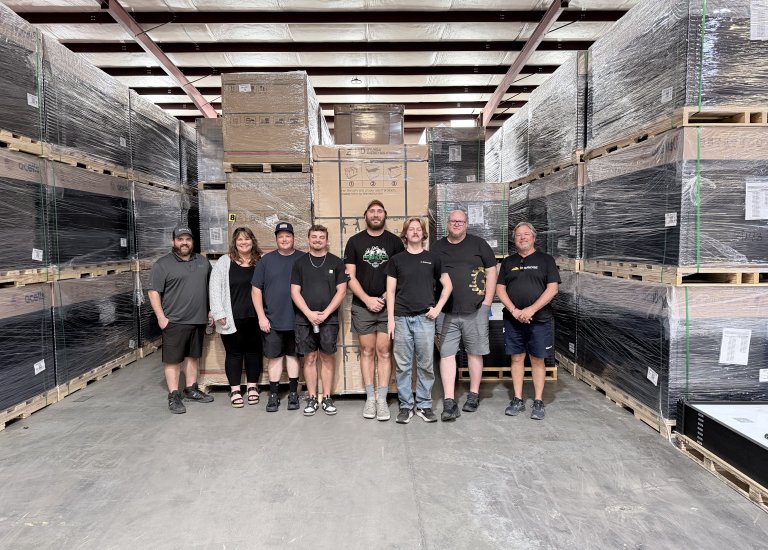 Greentech Pensacola team photo in warehouse.