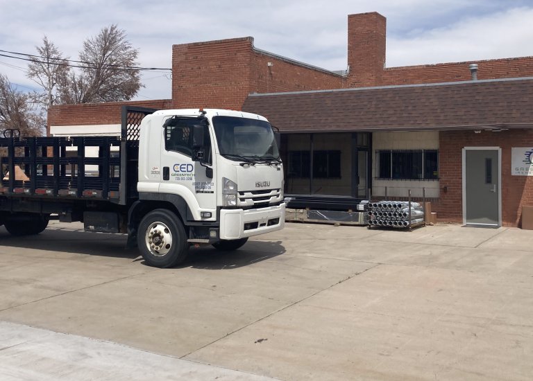 Greentech Renewables Pueblo building exterior and delivery truck.