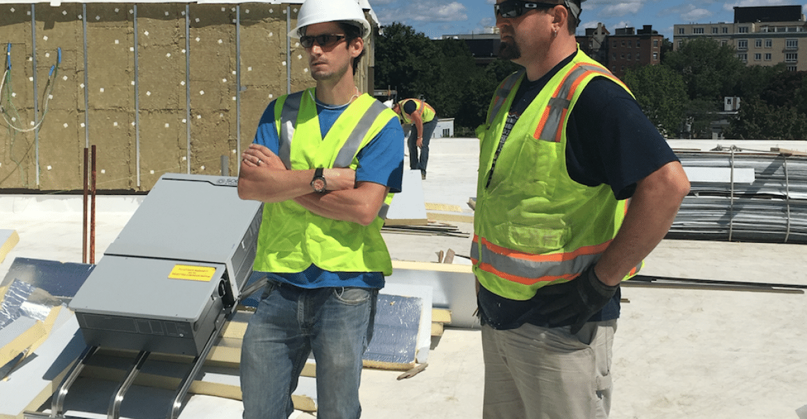 Greentech RenewablesSolar's Eric Lorenz (left) inspects the roof prior to installation. 