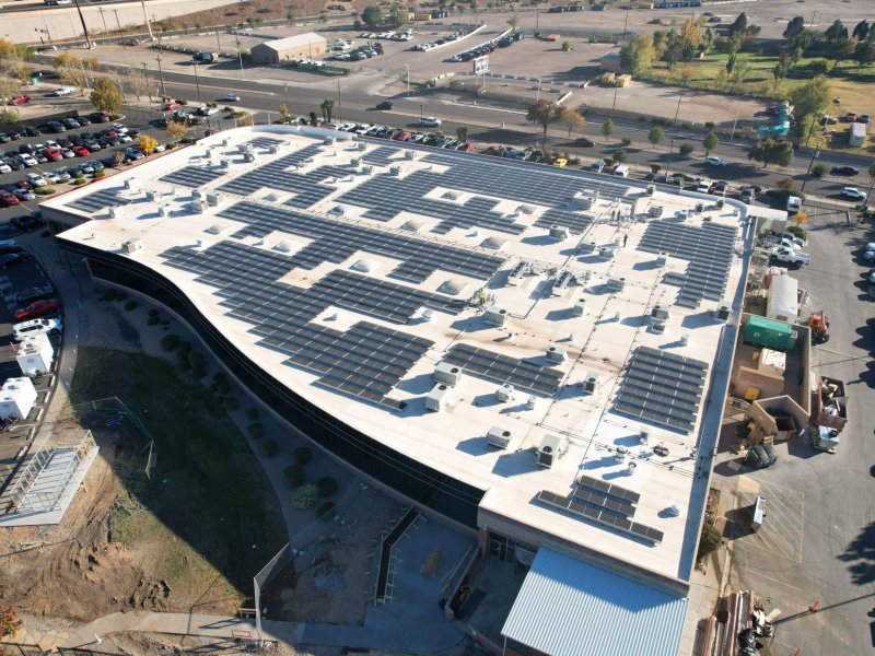 Angled view of rooftop commercial solar installation in Albuquerque, NM.
