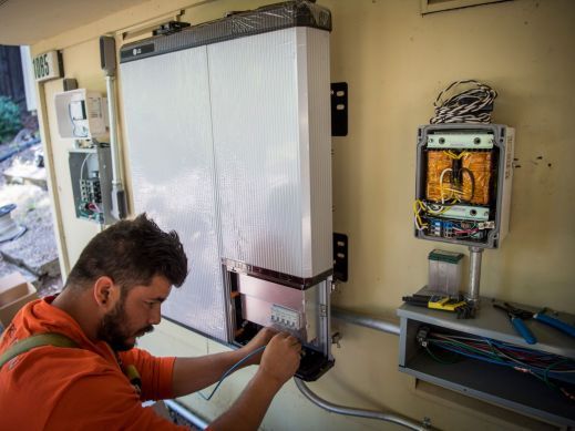 Contractor installing a solar battery