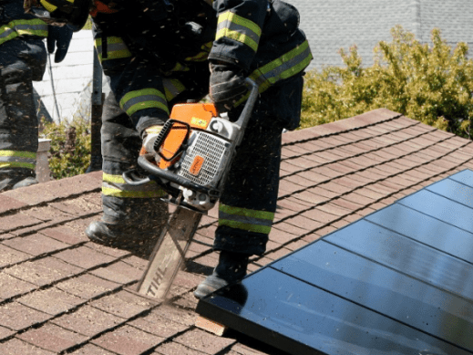 Firefighter entering a house with solar panels in an emergency situation 