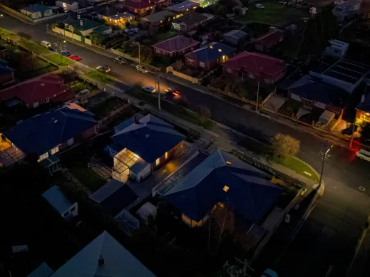 Aerial view of neighborhood with illuminated houses at night