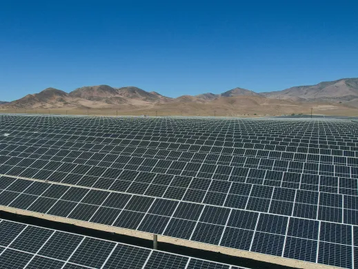 A large array of solar panels in a desert